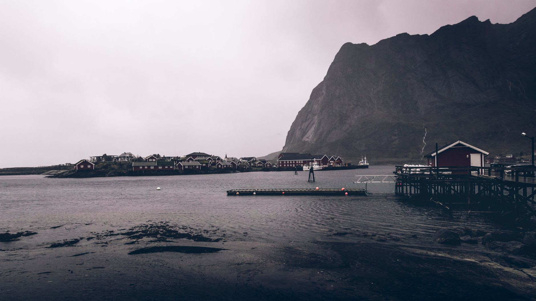 Northern fjord coastline showing remote wooden dwellings